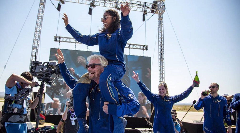 Victory lap: Richard Branson and Sirisha Bandla celebrate with the VSS Unity crew upon their successful return to Earth after their maiden flight on July 11
