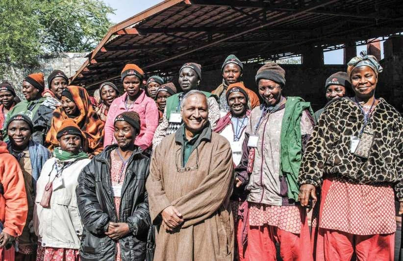 Bunker Roy with rural African women during a solar engeering training