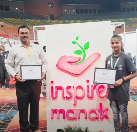 Pooja with her teacher